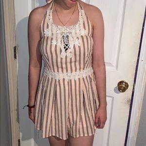 Peach colored romper with navy blue stripes